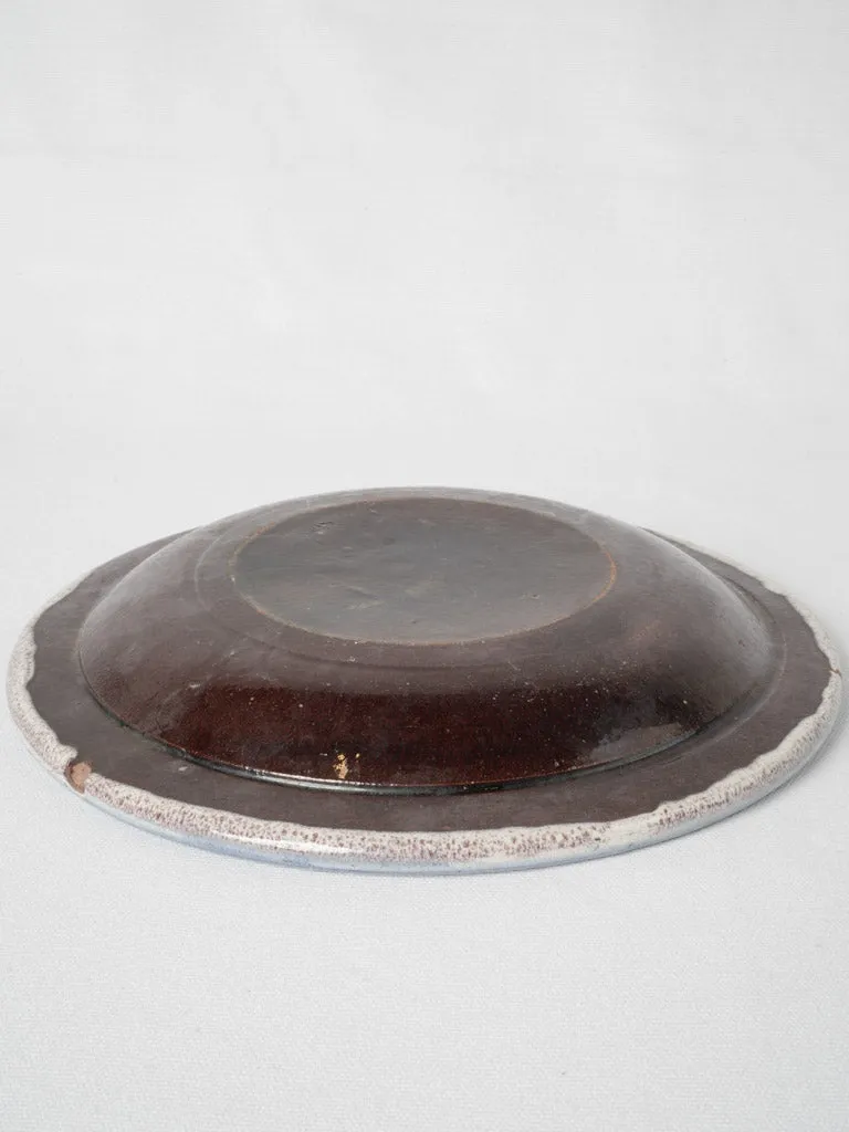 20th-century white glazed terra cotta plate w/ floral motifs 11¾"