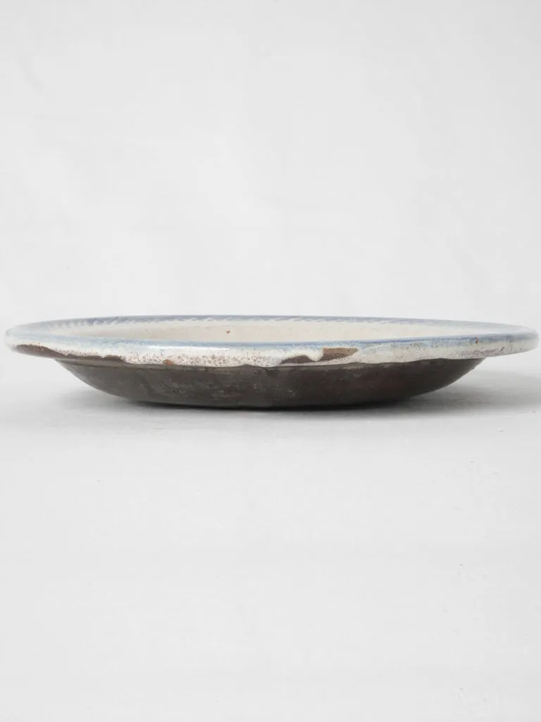 20th-century white glazed terra cotta plate w/ floral motifs 11¾"