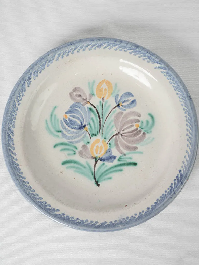 20th-century white glazed terra cotta plate w/ floral motifs 11¾"