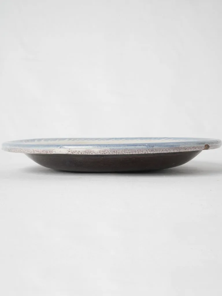 20th-century white glazed terra cotta plate w/ floral motifs 11¾"