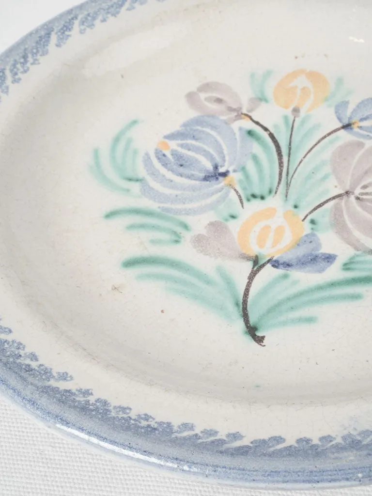 20th-century white glazed terra cotta plate w/ floral motifs 11¾"